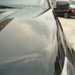 Before and after photographs of a damaged, black, Range Rover that was repaired by Elite Paint & Body Shop in West Palm Beach, FL.